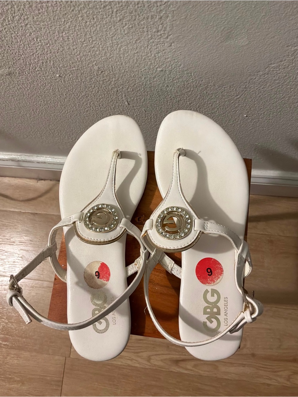 GBG Los Angeles White T-Strap Sandals with Gold Logo Accent